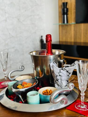 a table with a pot and a plate of food at Ellipse Apartment in Midrand