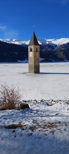 a building in the middle of a snow covered field at Marlingsuites - Vinea - Wieser Josef - Marling in Marlengo