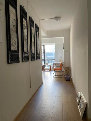 a hallway with pictures on the walls and a table at 合家欢 in Kunming