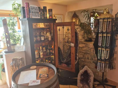 a room with a barrel and a shelf of bottles at Edelsteinhotel Guniwirt in Krakaudorf