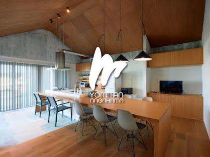 a dining room with a long table and chairs at オーシャンビューの静かな84平米の空間で暮らすように泊まる宿m yomitan nagahama in Yomitan