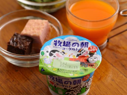 a container of food and a glass of orange juice at Dormy Inn EXPRESS Asakusa in Tokyo