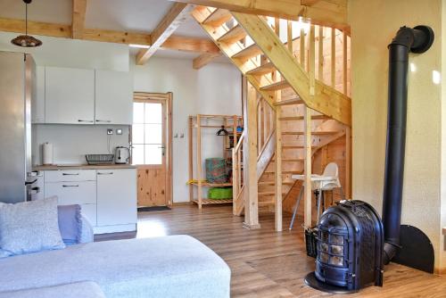 a living room with a kitchen and a staircase at Agroturystyka Trzy Siostry in Stronie Śląskie