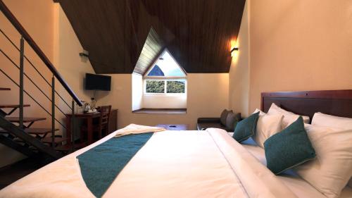 a bedroom with a large bed with a window at Shola Crown Resort - Munnar in Chinnakanal