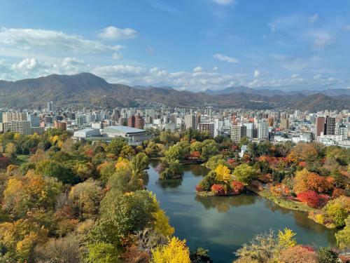 a city with a river and a city at Hotel Lifort Sapporo in Sapporo