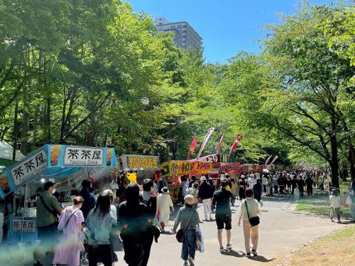 a large crowd of people walking down a street at Hotel Lifort Sapporo in Sapporo