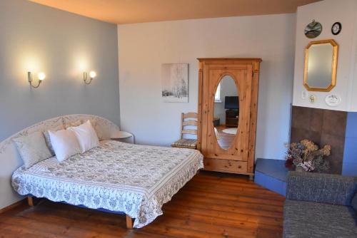 a bedroom with a bed and a large mirror at Uliha Apartamenti in Liepāja
