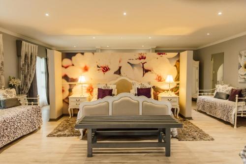 a bedroom with two beds and a white bench at Lavender Hill Country Estate and Wedding Venue in Bethlehem