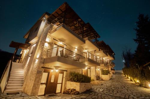 a building with stairs and lights at night at Villas Lirtzis in Taxiarchis