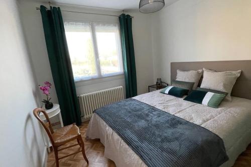 a bedroom with a large bed and a window at Maison 4 personnes dans village Cœur du perche avec toutes commodités Mini 2jours in Condé-sur-Huisne