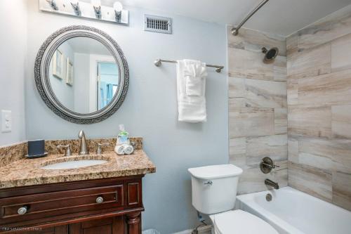 a bathroom with a sink and a toilet and a mirror at Harbor Tower Intracoastal Condo in Siesta Key