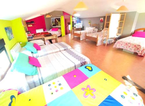 a living room with two beds and a living room with at CASA DEL HUEVO, 8 a 16 pers, RIOJA ALAVESA, a 15km de Logroño y Laguardia in Viñaspre