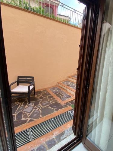 a view of a patio with a bench from a window at Aether Suites Tropea - Free Private Parking in Tropea