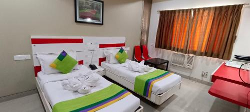 Ένα ή περισσότερα κρεβάτια σε δωμάτιο στο Hotel Bagga International