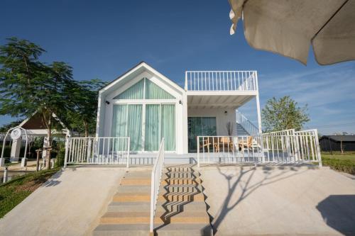 a house with a staircase leading up to it at Saksiam Lakeside Resort SHA PLUS Certificate in Nonthaburi