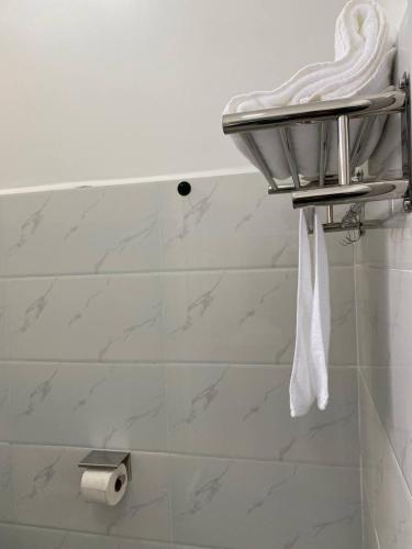 a bathroom with a white towel hanging from a sink at TARA 58 in Krong Poi Pet