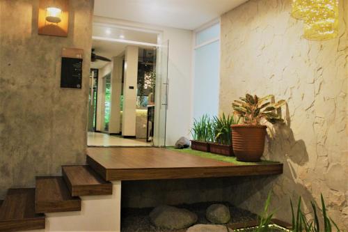 a hallway with a stairway with plants on it at Treehouse Suites - Boutique Serviced Apartment in Jakarta