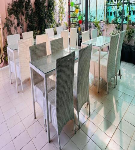 a glass table and chairs on a patio at Hotel The Omaira in Jaipur