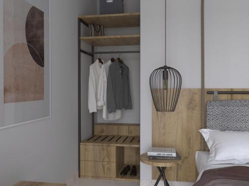 a room with a bedroom with a bed and a closet at Avaton Luxury Resort and Spa Access the Enigma - Adults Only & Kids 14 Plus- in Asprovalta