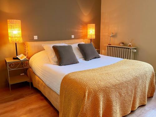 a bedroom with a large bed with two pillows on it at Le Chat Botté in Saint-Clément-des-Baleines