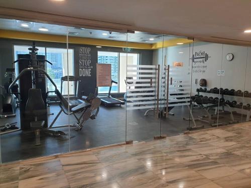 a gym with bikes and exercise equipment in a room at Large cozy Studio(Hamilton Residency) in Dubai