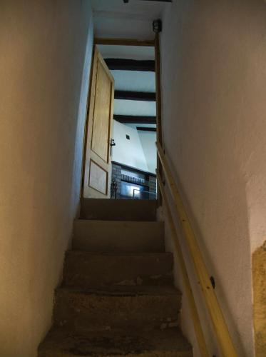 a stairway with a door and a stair case at Cal Moliner De Castelladral in Castelladral