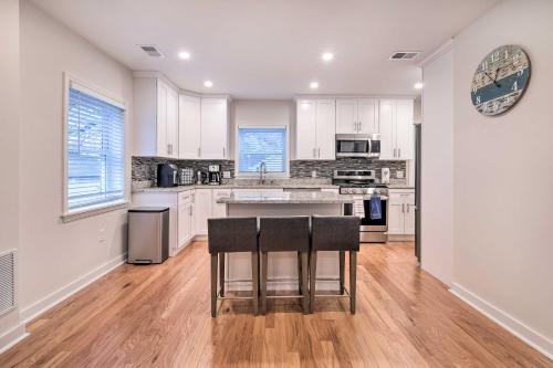 a kitchen with white cabinets and a table and chairs at Washington, DC, Vacation Rental By Arboretum in Washington, D.C.