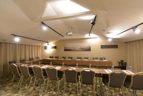 a large conference room with a long table and chairs at Waxwing Hotel in Hatay