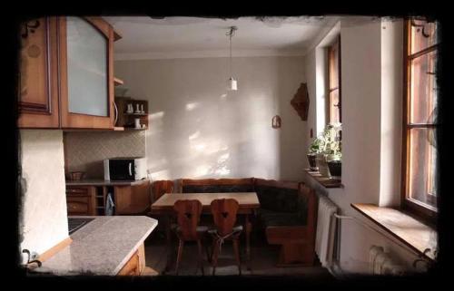 a living room with a couch and a table and chairs at Dwór Jeziory Wielkie in Jeziory Wielkie