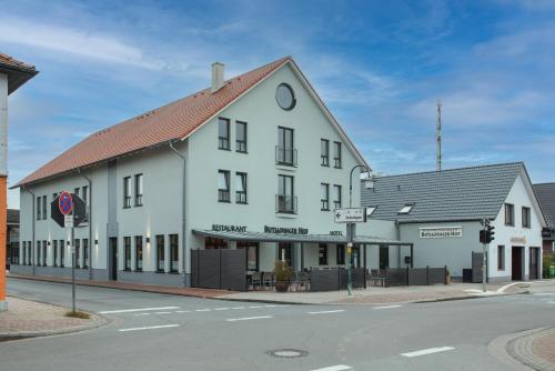 a white building on the corner of a street at Butjadinger Hof in Burhave