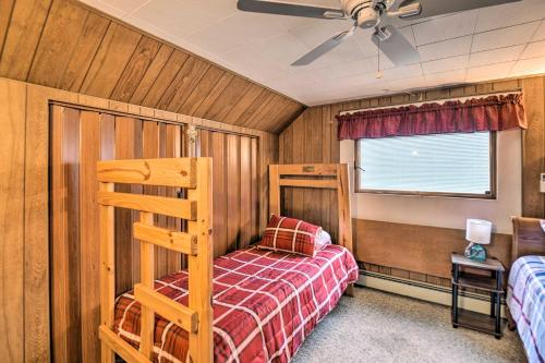 a bedroom with a bunk bed and a window at Cozy Berlin Getaway, ATV from the Driveway in Gorham
