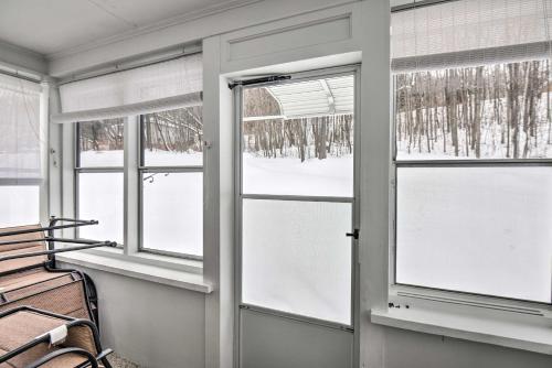 a room with three windows and a bench at Cozy Home with ATV Trail Access in Berlin! in Gorham