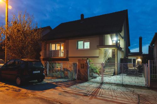 a house with a car parked in front of it at MyHome2 in Subotica