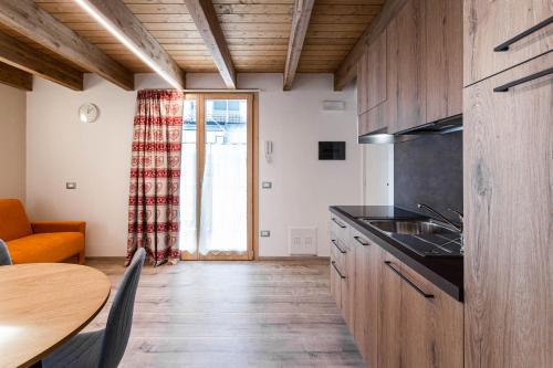 a kitchen with a table and a dining room at Residence Villa Brioschi in Aprica