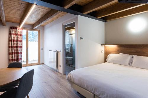アプリーカにあるResidence Villa Brioschiのベッドルーム1室(ベッド1台、テーブル付)、バスルーム1室が備わります。