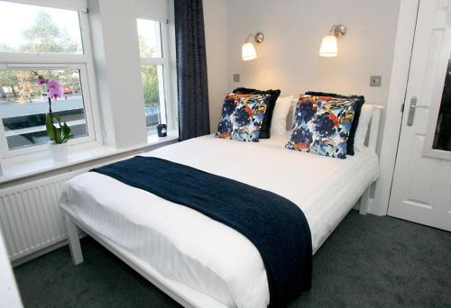 a bedroom with a bed with pillows and a window at The Sliding Rock Inn in Galway