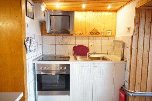 a small kitchen with a stove and a sink at My Home is my Castle in Hontheim