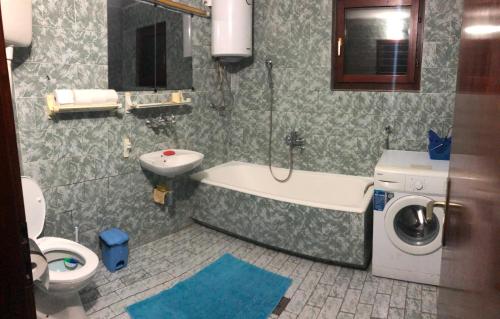 a bathroom with a tub and a toilet and a sink at Vila Bojana in Gornji Milanovac