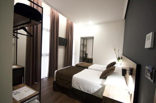 a hotel room with a bed and a mirror at Hotel BH San Francisco Alicante in Alicante