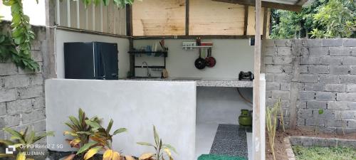 a small kitchen with a counter in a building at The Pondok in Kuta Lombok