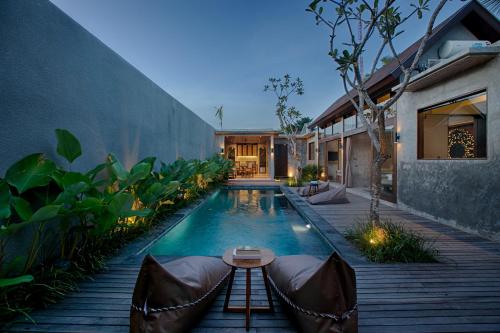 a swimming pool in the backyard of a house at Taman Dharmawangsa Suites in Nusa Dua