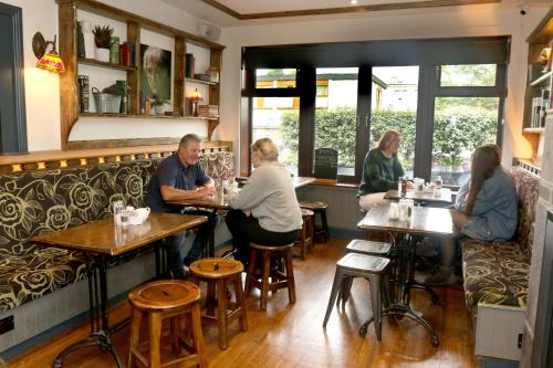 a group of people sitting at tables in a restaurant at The Sliding Rock Inn in Galway