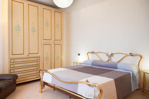 a bedroom with a bed and a chest of drawers at Giardino La Panoramica in Rio Marina