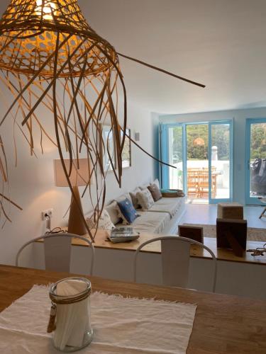 a living room with a couch and a large pendant at New! Casa do Mar - Pedralva - Sagres- Surf & Nature in Vila do Bispo