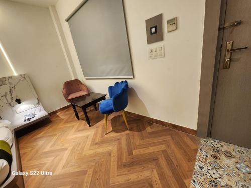 a room with a table and a chair and a chalkboard at Square9 - A Boutique Hotel in Gurgaon
