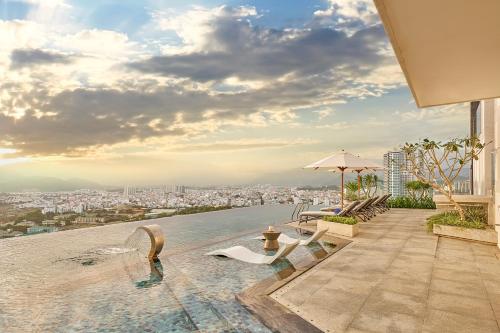 a pool on the roof of a building with a city at December Hotel in Nha Trang