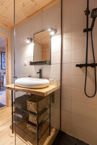 a bathroom with a sink and a mirror at Le chalet des bois in Lalaye