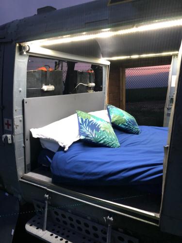 a bed in the back of a train with pillows at Helipod in Boston