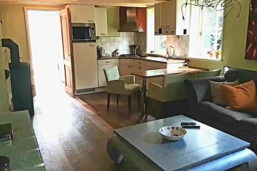 a kitchen and living room with a couch and a table at Farm apartment, self checkin in Anna Paulowna