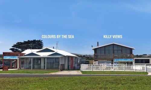 a building with a sign that reads colours by the sky at Stunning Waterfront only 10 minutes to Phillip Island - FREE EV UNIT 7kW for electric cars - pet friendly, fireplace FREE WIFI wine & chocolates in Kilcunda